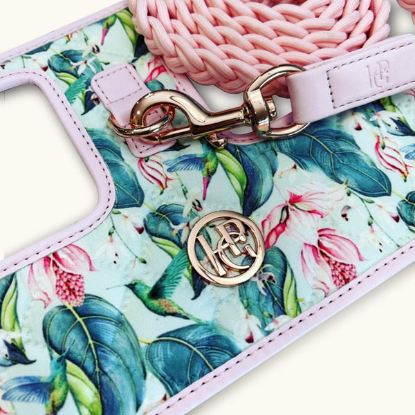 Floral-patterned hummingbird dog harness with pink strap and gold clasp