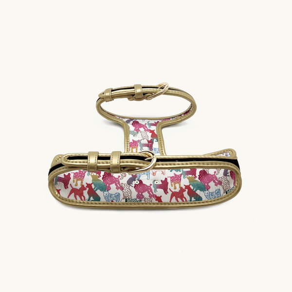Rear of midnight lack Dog harness with colorful animal pattern and gold buckles
