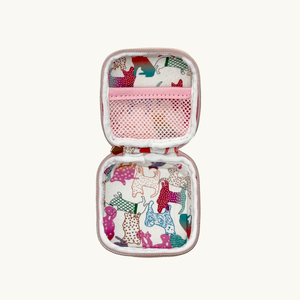 Baby pink dog waste/treat bag opened with animal pattern on a white background