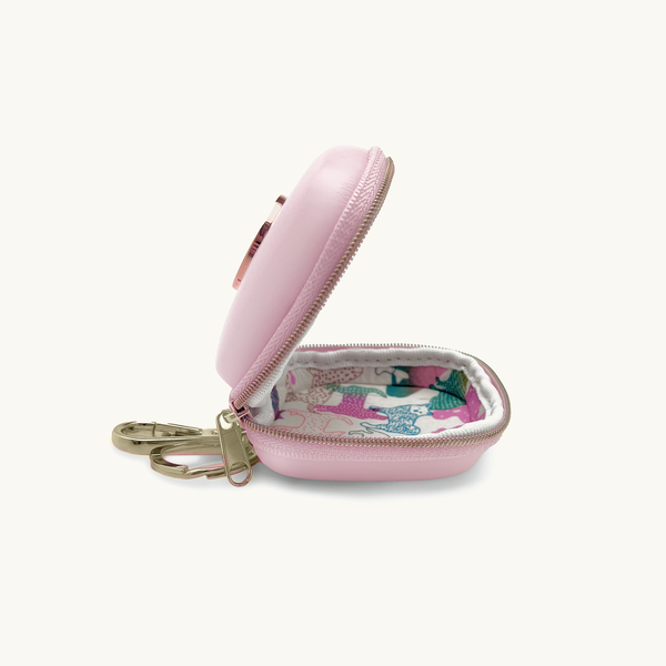 Baby pink dog waste/treat bag with gold logo and keychain opened with floral inner lining
