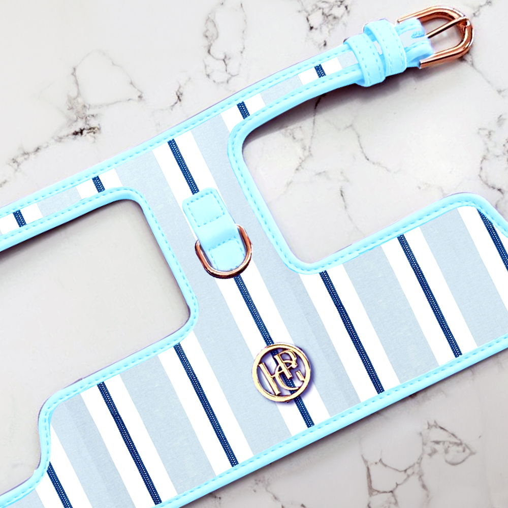 Dapper Sailor Dog harness with blue and white striped pattern on a marble surface